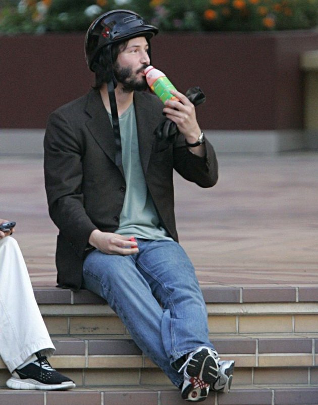 11 celebrities who have made millions but lead a normal life Keanu Reeves is resting sitting on a street staircase