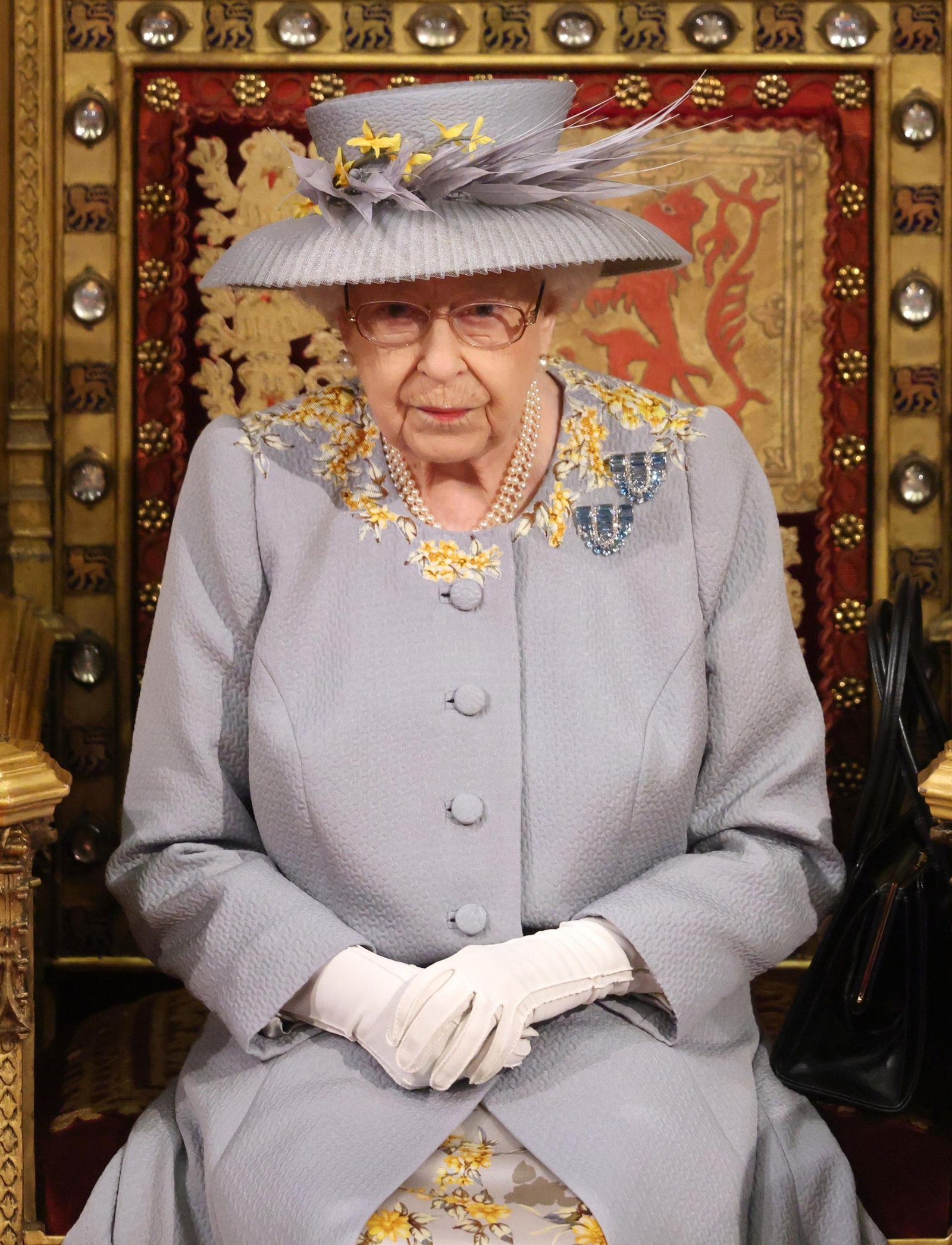 A sad sight: For the first time Queen Elizabeth sits alone on the throne, without her 'support and strength'