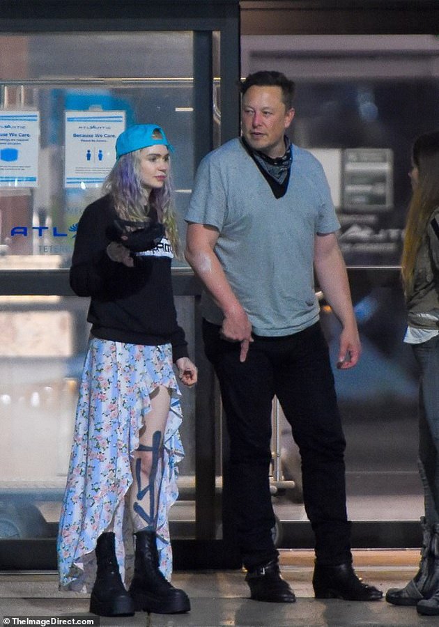 Elon Musk with his wife and little son at the airport