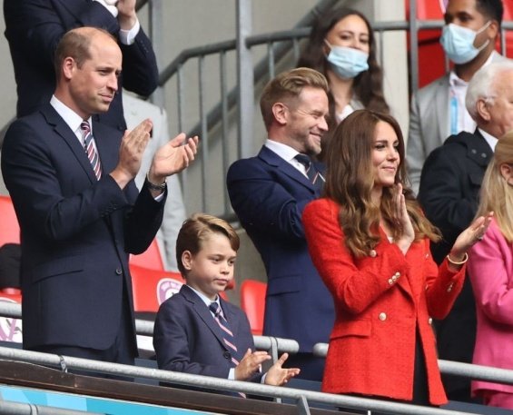 Duchess Catherine and Prince William with little Prince George at a football match