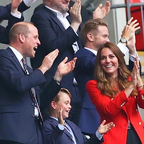 Duchess Catherine and Prince William with little Prince George at a football match