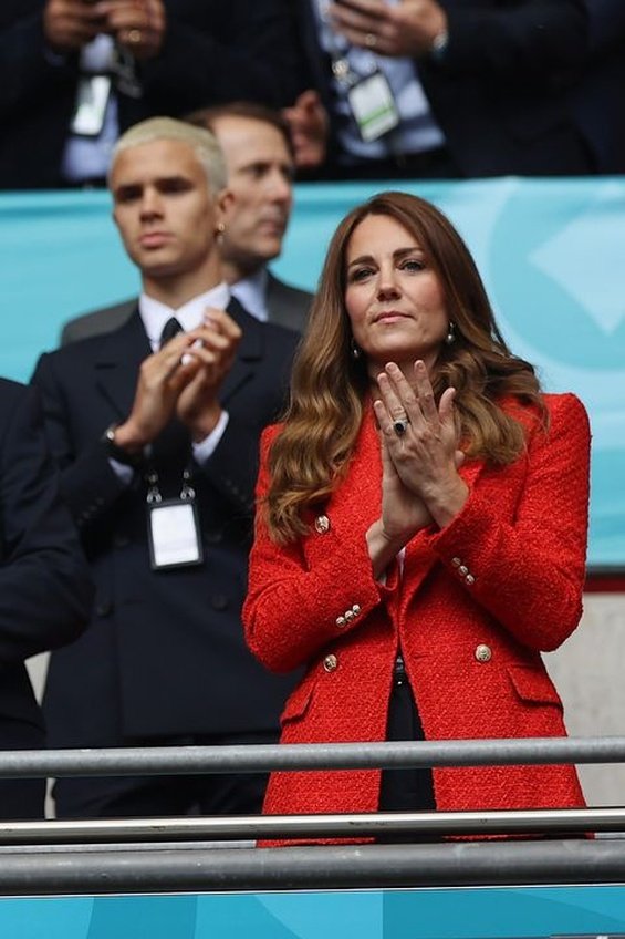 Duchess Catherine and Prince William with little Prince George at a football match