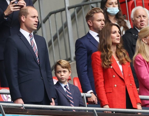 Duchess Catherine and Prince William with little Prince George at a football match