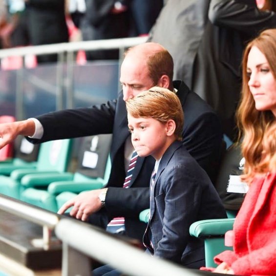 Duchess Catherine and Prince William with little Prince George at a football match