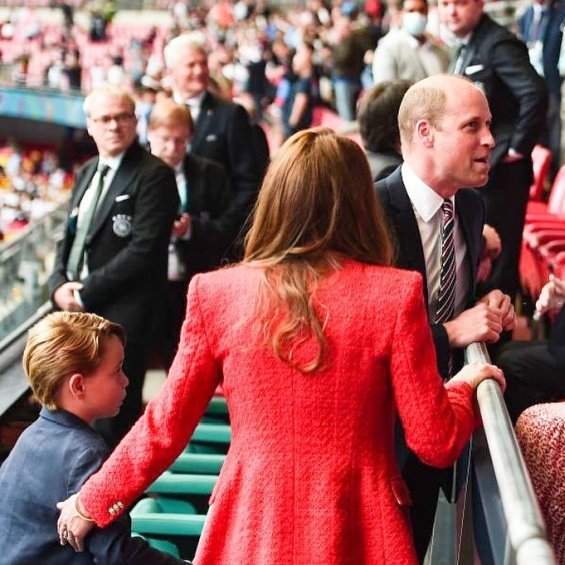 Duchess Catherine and Prince William with little Prince George at a football match