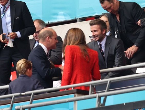 Duchess Catherine and Prince William with little Prince George at a football match