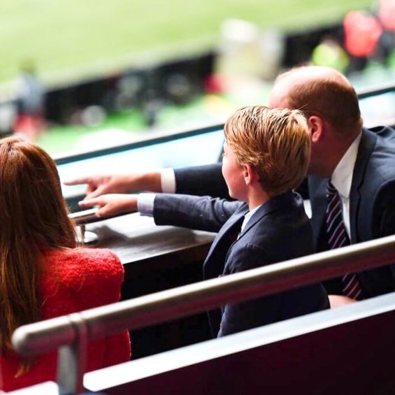 Duchess Catherine and Prince William with little Prince George at a football match