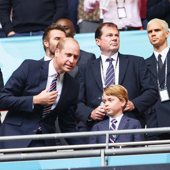 Duchess Catherine and Prince William with little Prince George at a football match