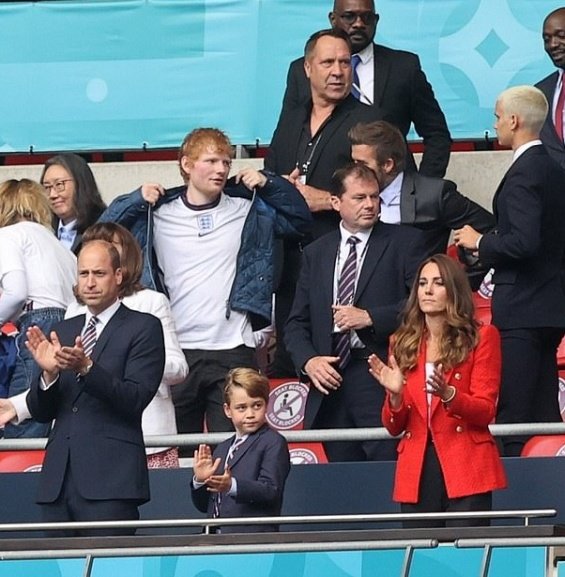 Duchess Catherine and Prince William with little Prince George at a football match