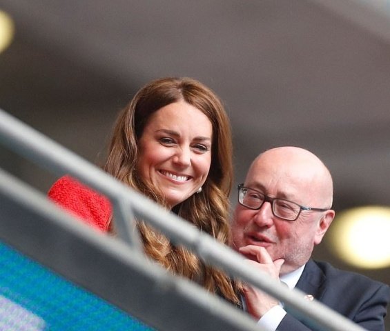 Duchess Catherine and Prince William with little Prince George at a football match