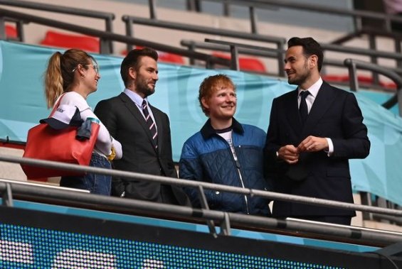 Duchess Catherine and Prince William with little Prince George at a football match