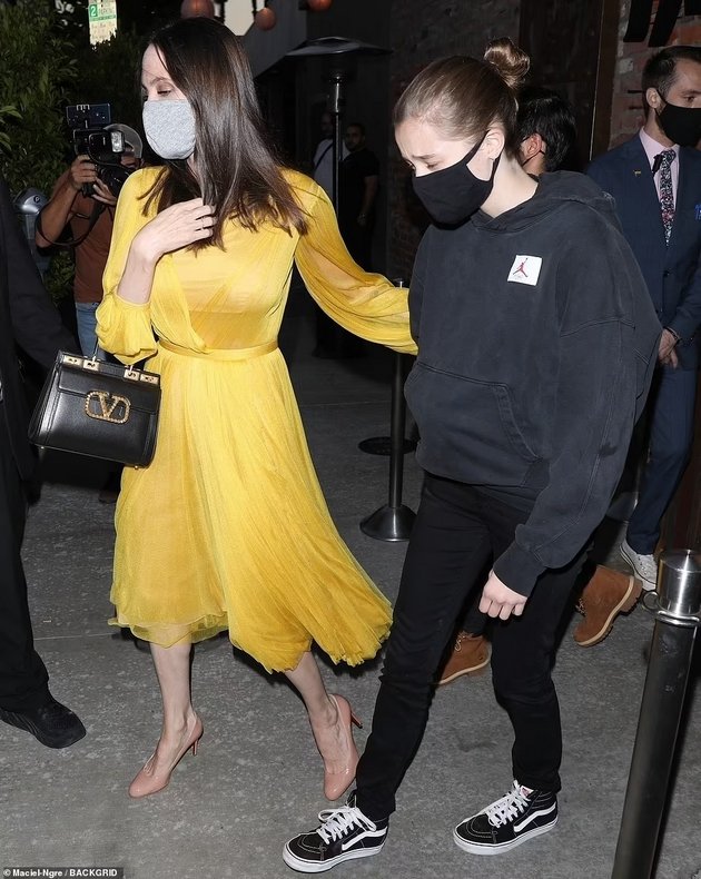 Angelina Jolie at a dinner with the children in a yellow dress for the 46th birthday