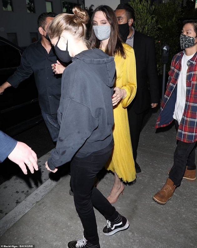 Angelina Jolie at a dinner with the children in a yellow dress for the 46th birthday