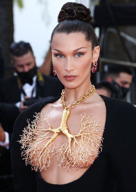Bella Hadid in a black dress and striking jewelry on her chest at the Cannes Film Festival