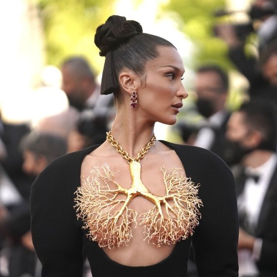 Bella Hadid in a black dress and striking jewelry on her chest at the Cannes Film Festival