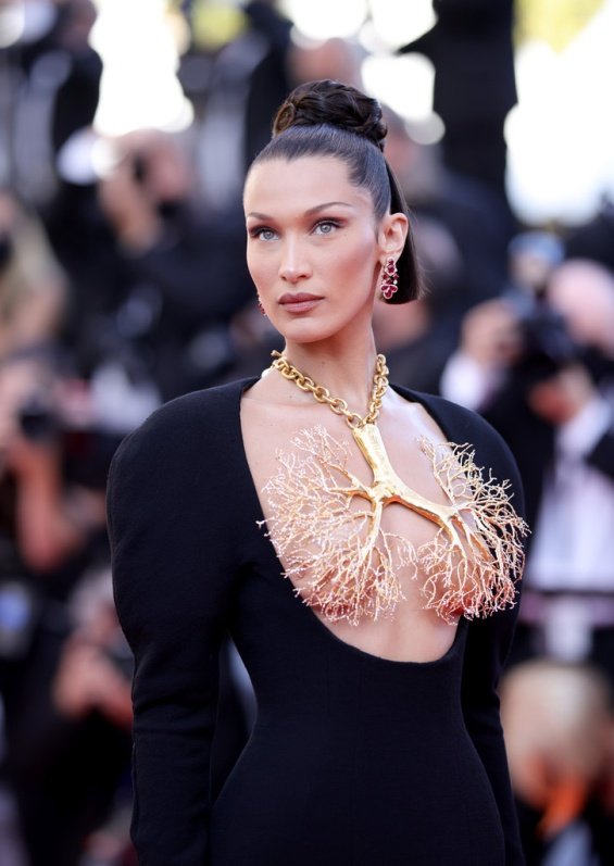 Bella Hadid in a black dress and striking jewelry on her chest at the Cannes Film Festival