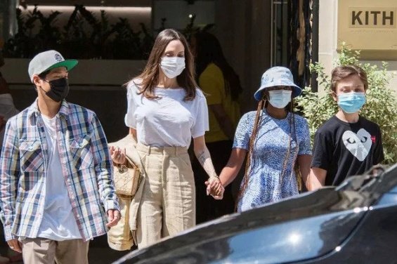 Angelina Jolie in several stylings with children in Paris