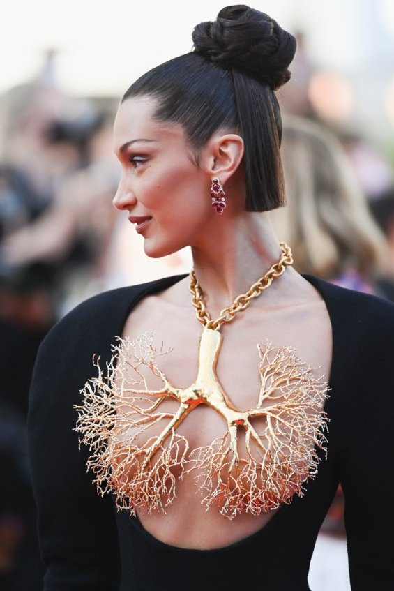 Bella Hadid in a black dress and striking jewelry on her chest at the Cannes Film Festival