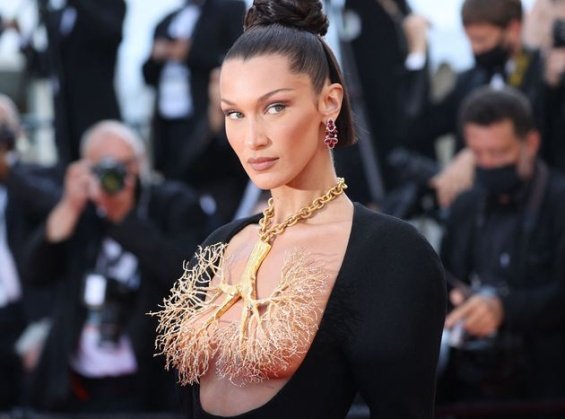 Bella Hadid in a black dress and striking jewelry on her chest at the Cannes Film Festival