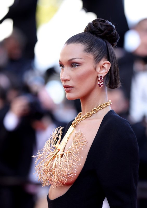 Bella Hadid in a black dress and striking jewelry on her chest at the Cannes Film Festival