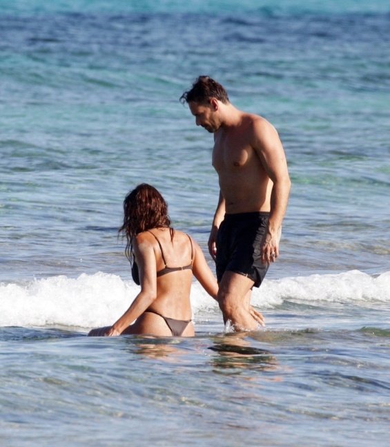 Irina Shayk enjoys the beach in Ibiza while Bradley Cooper takes care of their daughter