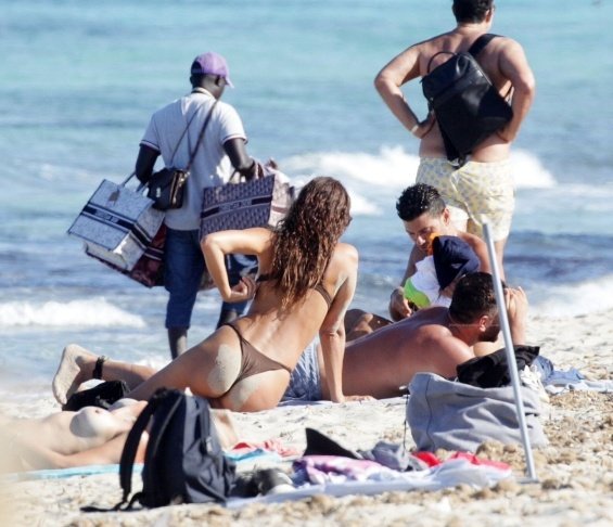 Irina Shayk enjoys the beach in Ibiza while Bradley Cooper takes care of their daughter