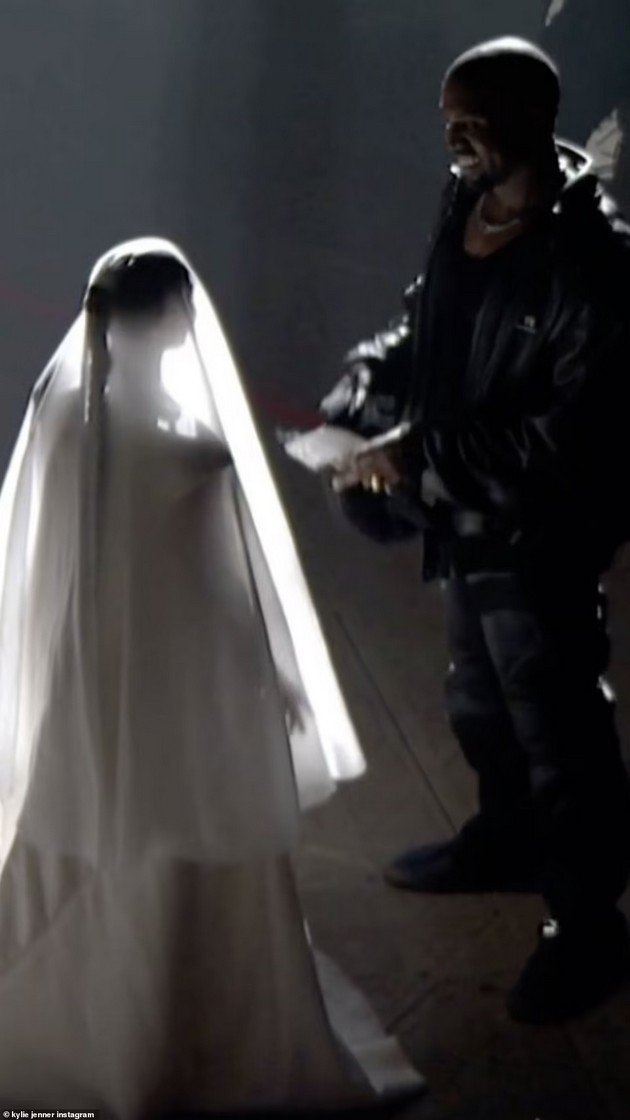 Kim Kardashian in a wedding dress at the promotion of Kanye's album, after he decided to change his name