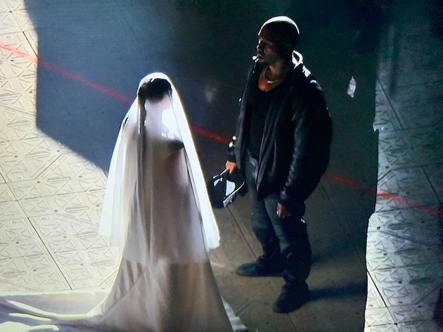 Kim Kardashian in a wedding dress at the promotion of Kanye's album, after he decided to change his name