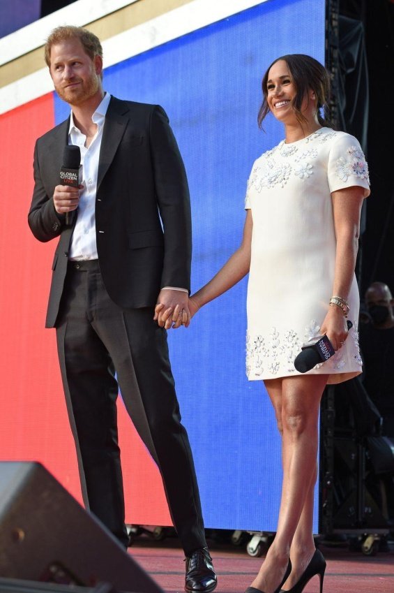 Meghan Markle in a white creation from Valentino next to Prince Harry at an event in New York