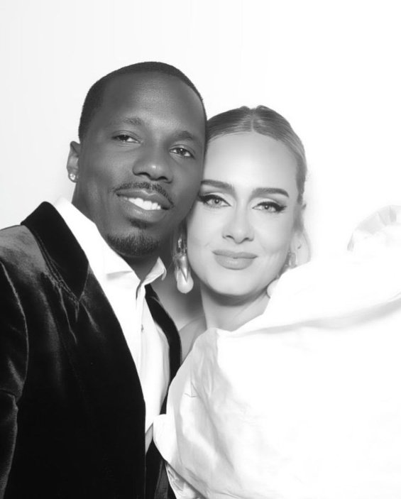 Adele glamorous in black and white creation with her new boyfriend at a wedding