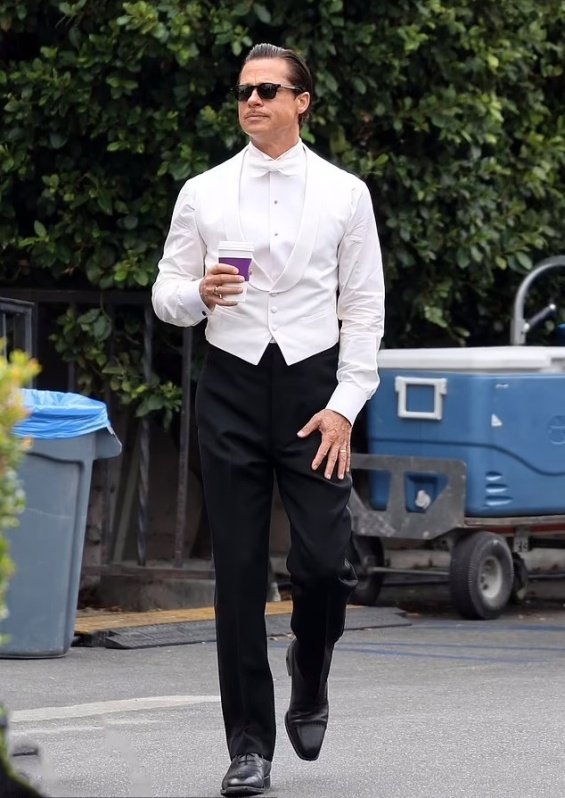 Hollywood seducer: Brad Pitt ultra sleek in suit photographed on the set of the new movie