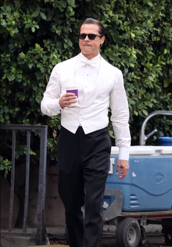 Hollywood seducer: Brad Pitt ultra sleek in suit photographed on the set of the new movie