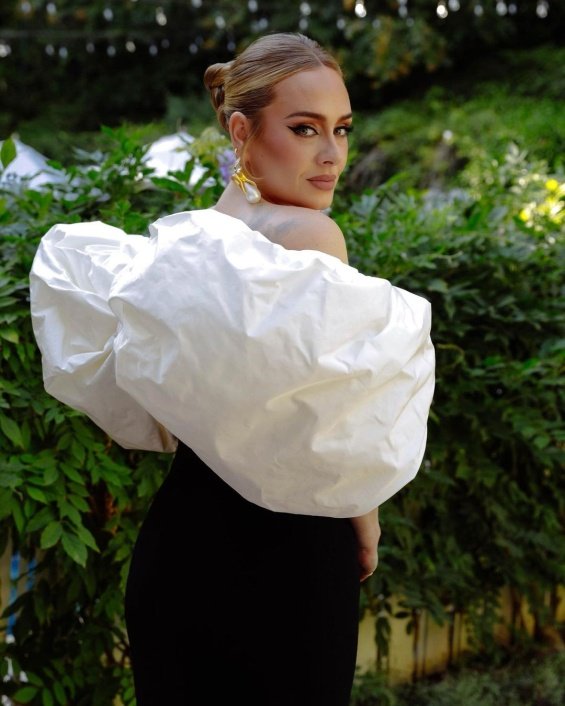 Adele glamorous in black and white creation with her new boyfriend at a wedding