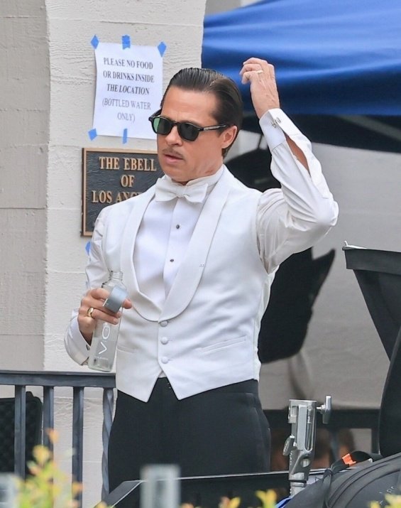 Hollywood seducer: Brad Pitt ultra sleek in suit photographed on the set of the new movie