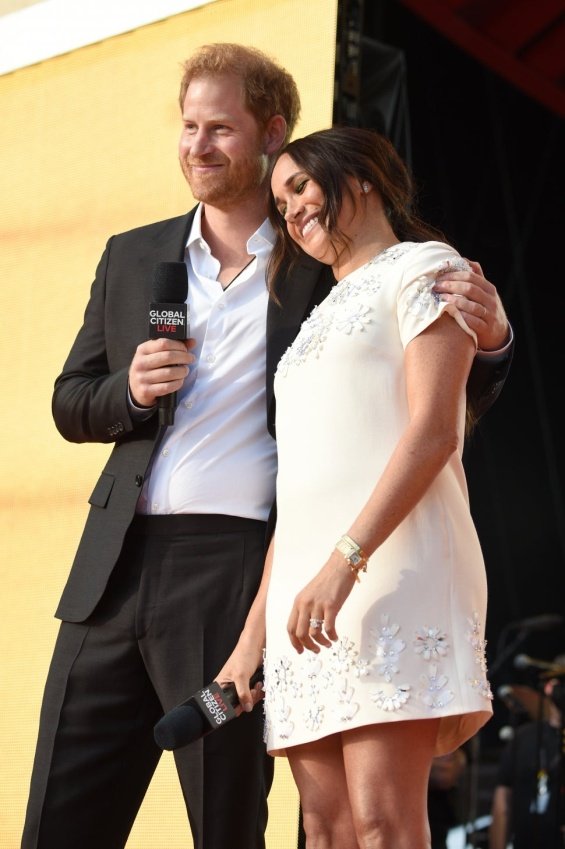 Meghan Markle in a white creation from Valentino next to Prince Harry at an event in New York