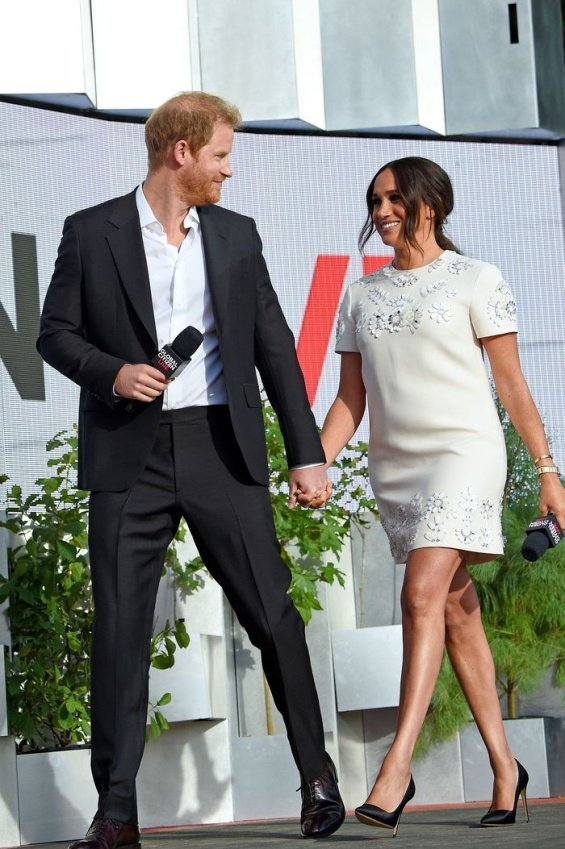 Meghan Markle in a white creation from Valentino next to Prince Harry at an event in New York