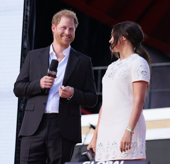 Meghan Markle in a white creation from Valentino next to Prince Harry at an event in New York