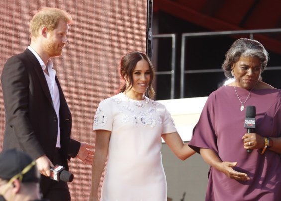 Meghan Markle in a white creation from Valentino next to Prince Harry at an event in New York