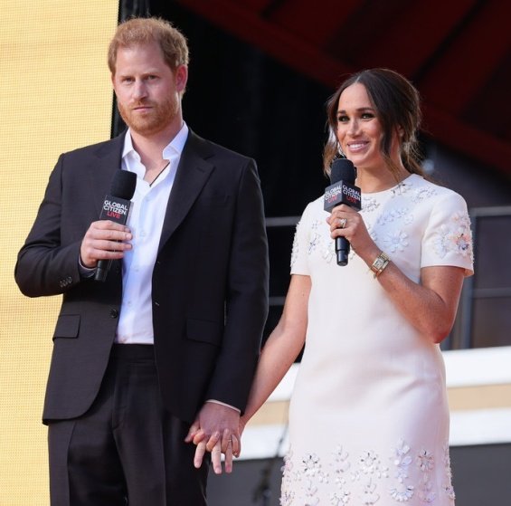 Meghan Markle in a white creation from Valentino next to Prince Harry at an event in New York