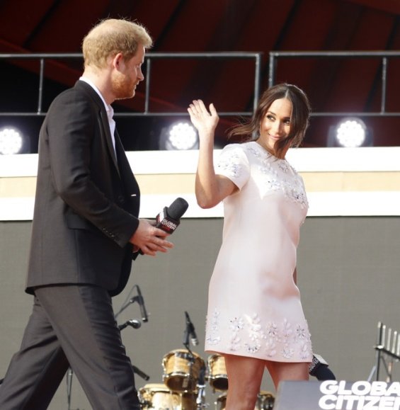 Meghan Markle in a white creation from Valentino next to Prince Harry at an event in New York
