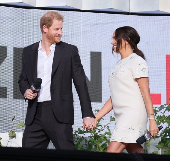 Meghan Markle in a white creation from Valentino next to Prince Harry at an event in New York