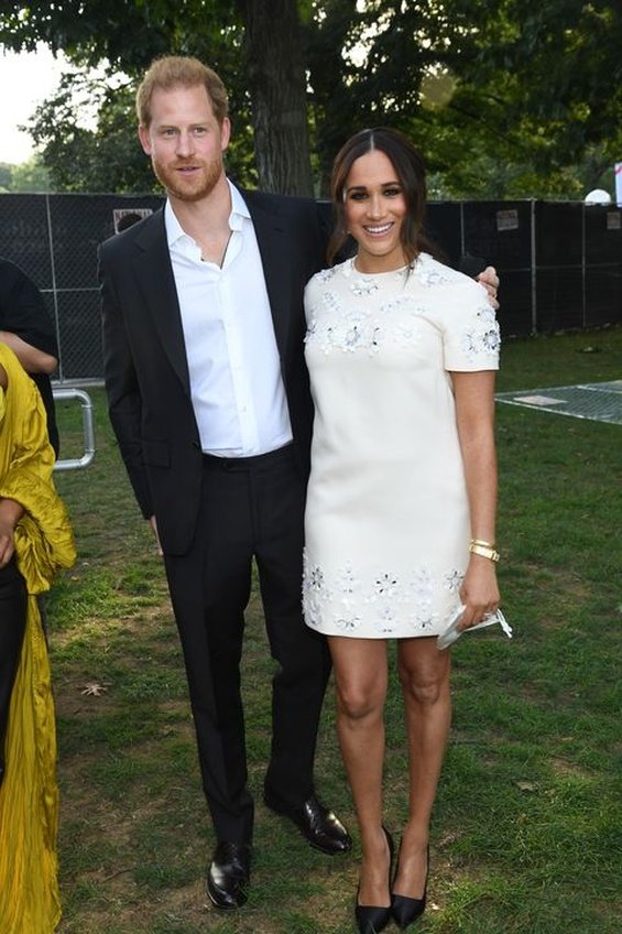 Meghan Markle in a white creation from Valentino next to Prince Harry at an event in New York