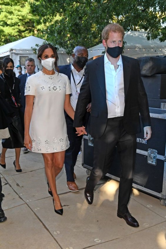 Meghan Markle in a white creation from Valentino next to Prince Harry at an event in New York