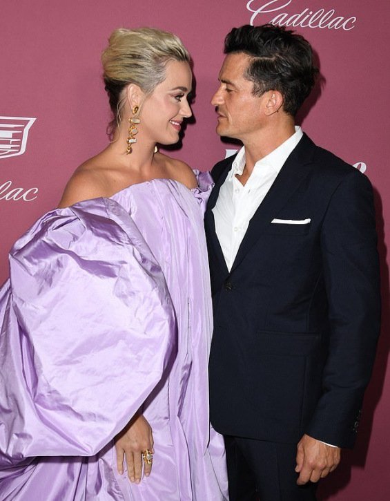 Katy Perry in a voluminous creation next to Orlando Bloom at the Power of Women event