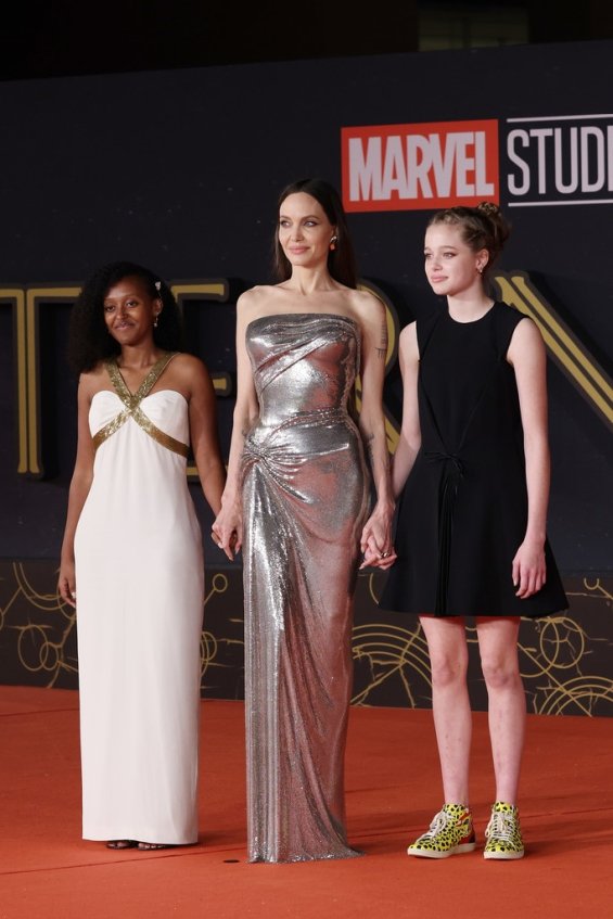 Angelina Jolie shines in a silver creation with her 2 eldest daughters at a premiere in Rome