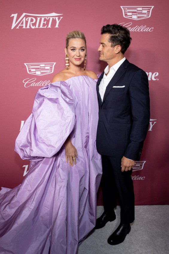 Katy Perry in a voluminous creation next to Orlando Bloom at the Power of Women event