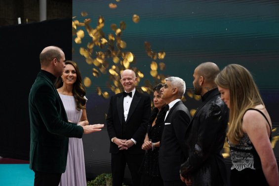 Duchess Catherine in a creation by Alexander McQueen with Prince William at an awards ceremony in London