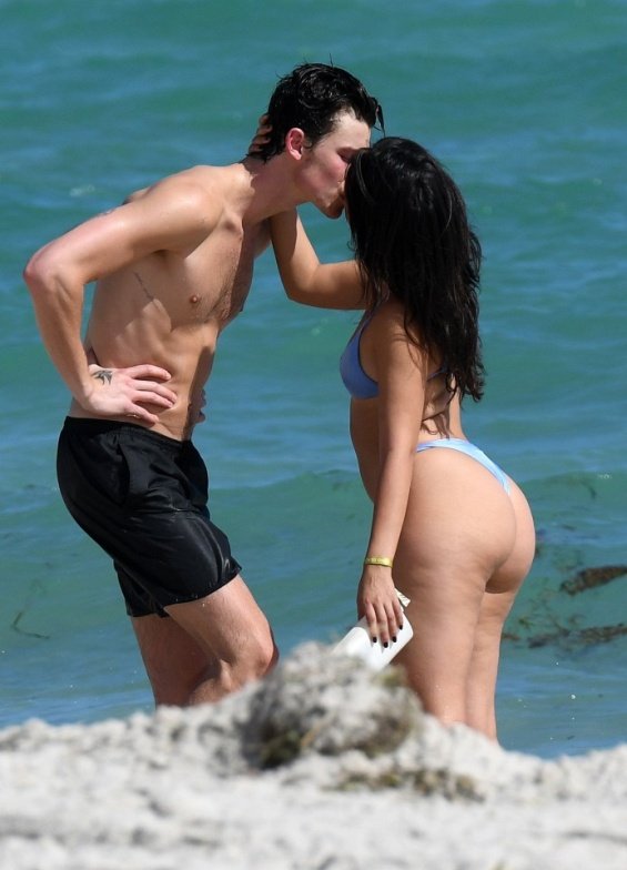 Camila Cabello in a blue bikini kisses Shawn Mendes on the beach in Miami