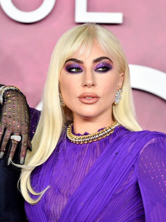 Lady Gaga strikes in a purple dress by Gucci at the premiere of House of Gucci