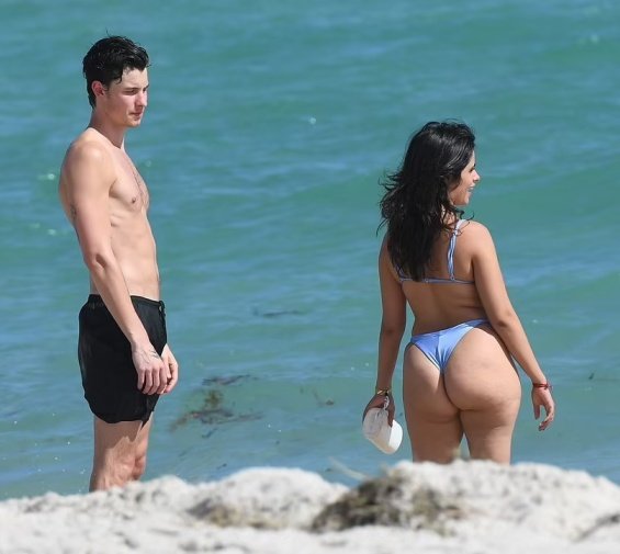 Camila Cabello in a blue bikini kisses Shawn Mendes on the beach in Miami